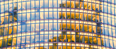 facade of a city building with office lights on